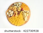 Cheese plate: Parmesan, cheddar, gouda, mozzarella and other with chili pepper and almonds on wooden board. Tasty appetizers. Isolated. Top view.