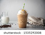 caramel frappe with wipped cream on marble table 