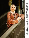 Small photo of Potraiture of beautiful young asian model in fashionable hijab style in outdoor. Malay girl in traditional Malay sarong batik and silk top.
