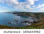 A panorama of rugged coastline in northern Spain during autumn