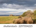 Grassy field with rocks in the...