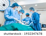 Small photo of Doctor and assistant nurse operating for help patient from dangerous emergency case .Surgical instruments on the sterile table in the emergency operation room in the hospital.Health care and Medical