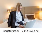 Happy business woman at hotel room working on a laptop on the bed and smiling lifestyle concepts, Business trip