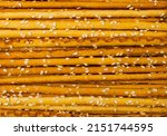 Small photo of Bread sticks texture background. Pretzel sticks pattern, straws, sesame grissini wallpaper, pretzels snack, breadstick with sesame seeds, long rusks with copy space