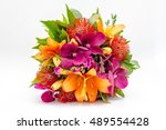 Small photo of Bouquet of flowers made of Orchid, lilias and nutans in vase on white background
