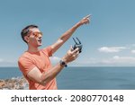 Man photographer or videographer as a pilot of uav. Flight of a drone using a wireless remote control over a radio channel