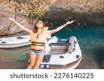 Small photo of girl seems completely captivated by the stunning beauty of the cave lake, as evidenced by the rapt expression on her face as she takes in the breathtaking scenery.