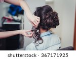 Closeup hairdresser coiffeur makes hairstyle.