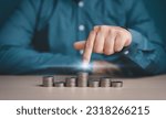 Small photo of Investor, Trader, Analyst, Funder, Stock marketer, or Businessman pointing on stacked coins for interest rating investment, Financial profit, and world economic growth and marketing control concept.