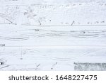 abstract aerial view of snow-covered road with tire tracks. winter transport concept background