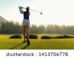 Small photo of Healthy Sport. Asian Sporty woman golfer player doing golf swing tee off on the green evening time, she presumably does exercise. Healthy Lifestyle Concept.