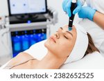 Small photo of Caucasian woman receiving facial procedure of cleansing the skin. Portrait and natural woman face with healthy freckle skin texture. Aesthetic, facial and skincare cosmetology