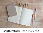 Blank notebook and pen on office wood table background. Business concept with copy space for any design