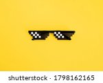 Small photo of Funny swag pixilated boss sunglasses on yellow background. Gangster, Black thug life meme glasses. Pixel 8bit style