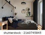 Small photo of Comfortable and stylish bedroom with big, cozy bed with nice bedclothes, many decorations and big window behind dark curtains
