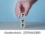 Small photo of hand holding question mark concept questions and answers Frequently asked questions Frequently asked questions Analysis of the consumer market and competitors