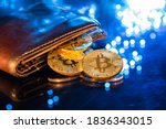 Bitcoin gold coins with wallet, close-up. Virtual cryptocurrency concept.