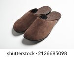 Small photo of Pair of blank soft brown home slippers, design mockup. Hotel bath slippers top view isolated on white background. Clear warm domestic sandal or sneakers. Bed shoes accessory footwear.