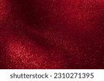 Abstract strains of gold particles in a red liquid. A mysterious glistening fluid background. Golden glittering particles on dark red background.