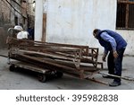 Small photo of BAKU, AZERBAIJAN - APRIL 24 2014 Hand trailer with taxi sign being pulled by a man in Baku, capital of Azerbaijan. An unusual taxi in Sovietskaya, a relatively unmodernized part of Baku