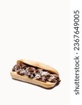Whole philly cheese steak with melting cheese on a white background with message area at top of frame
