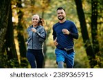 Happy athletic couple jogging...