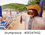 Small photo of Funny scarecrow on beach. Stylish bogeyman on Phuket island, Thailand.