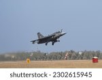 Small photo of Indian fighter jet in sky maneuver.Landing with parachute