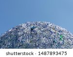 semicircular mountain of plastic waste, plastic bottles with a beautiful blue background