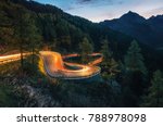 The winding mountain road with light tracks from cars at the evening, Maloja Pass, Switzerland