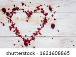 Small photo of Red Rose wither Petals Heart on White wood ground with copy space,abstract background,old love but Unceasing