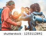 Group of happy trekkers stacking hands outdoor - Young hiker friends supporting each others - Survival, team, travel, success and adventure concept - Focus on hands