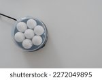 Small photo of Top view of egg cooker or egg boiler with white eggs with lid.