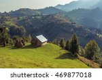 Mountain landscape in Romania with wooden hut. Landscape in Magura village with the Carpathian Mountains in the background. Traditional Romanian mountains panorama.  
