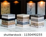 Kitchen counter top color samples made of natural granite, marble and quartz stone inside the countertop store on the white carrara marble slab