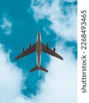 Small photo of Aeroplane in flight beneath a blue sky with clouds, low flying plane, airbus aircraft