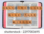 Small photo of Vancouver, BC, Canada - Circa April 2023: Scrabble letters spelling Bible Verse 1 Chronicles 22:12 Only the Lord give thee wisdom
