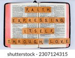 Small photo of Vancouver, BC, Canada - Circa May 2023: Scrabble letters spelling Bible Verse Galatians 5:6 Faith expressing itself through Love