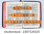 Small photo of Vancouver, BC, Canada - Circa May 2023: Scrabble letters spelling Bible Verse Galatians 2:16 But by faith in Jesus Christ