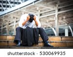 Business man who lost job abandoned lost in depression sitting on the subway stair suffering emotional pain. Businessman who have trouble with his job.Portrait of unhappy man under depression.