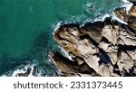 Alma Bay Beach at Arcadia at Magnetic Island near Townsville in Queensland, Australia - Aerial drone footage with rocks, waves, cliffs, ocean, trees, coast, views and scenery.