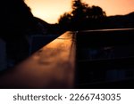 Small photo of Sunset with reflexion on wet wood