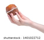 Muffin sweet bakery in hand on white background isolation