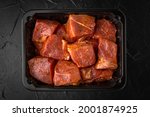 Pieces of pork or beef meat for barbecue marinated in spices and chilled in a disposable package, ready for sale, for eating, or long-term freezing