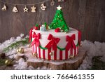 Christmas cake decorated with sweet figures of  Christmas tree, Santa, bears, deer, fir-tree, sleigh