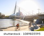 Cyclists along Red River in a sunny day, Winnipeg - Canada 