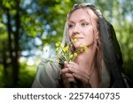 Small photo of Beautiful seductive dryad. Pagan spirit of forest. Portrait of beautiful dryad. Fairy who loves nature in beautiful green summer forest. Concept of environmental friendliness and caring for nature