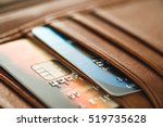 Credit cards in brown wallet in shallow focus