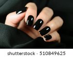 Manicure on female hands with black nail polish