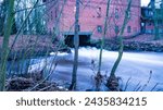 Small photo of small waterworks for energy production, old building, winter, long-term exposure